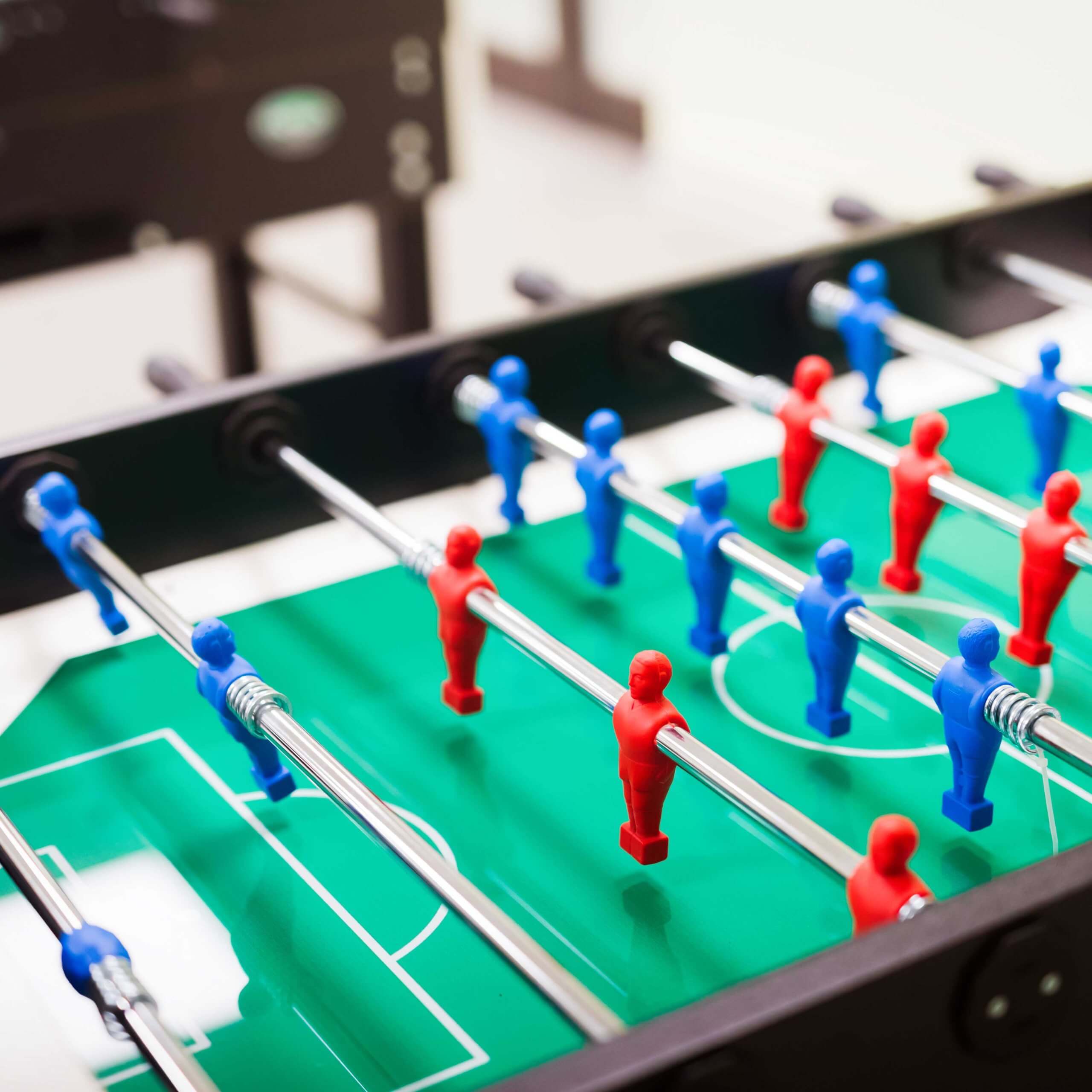 An image of a table football table, a visual metaphor for the topic of this article: Match-fixing, betting, and doping in football: Lessons from last season