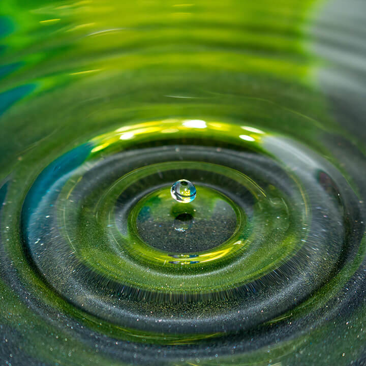 An image of a droplet of water landing into a pool, a visual metaphor for the topic of this article - the washing phenomenon